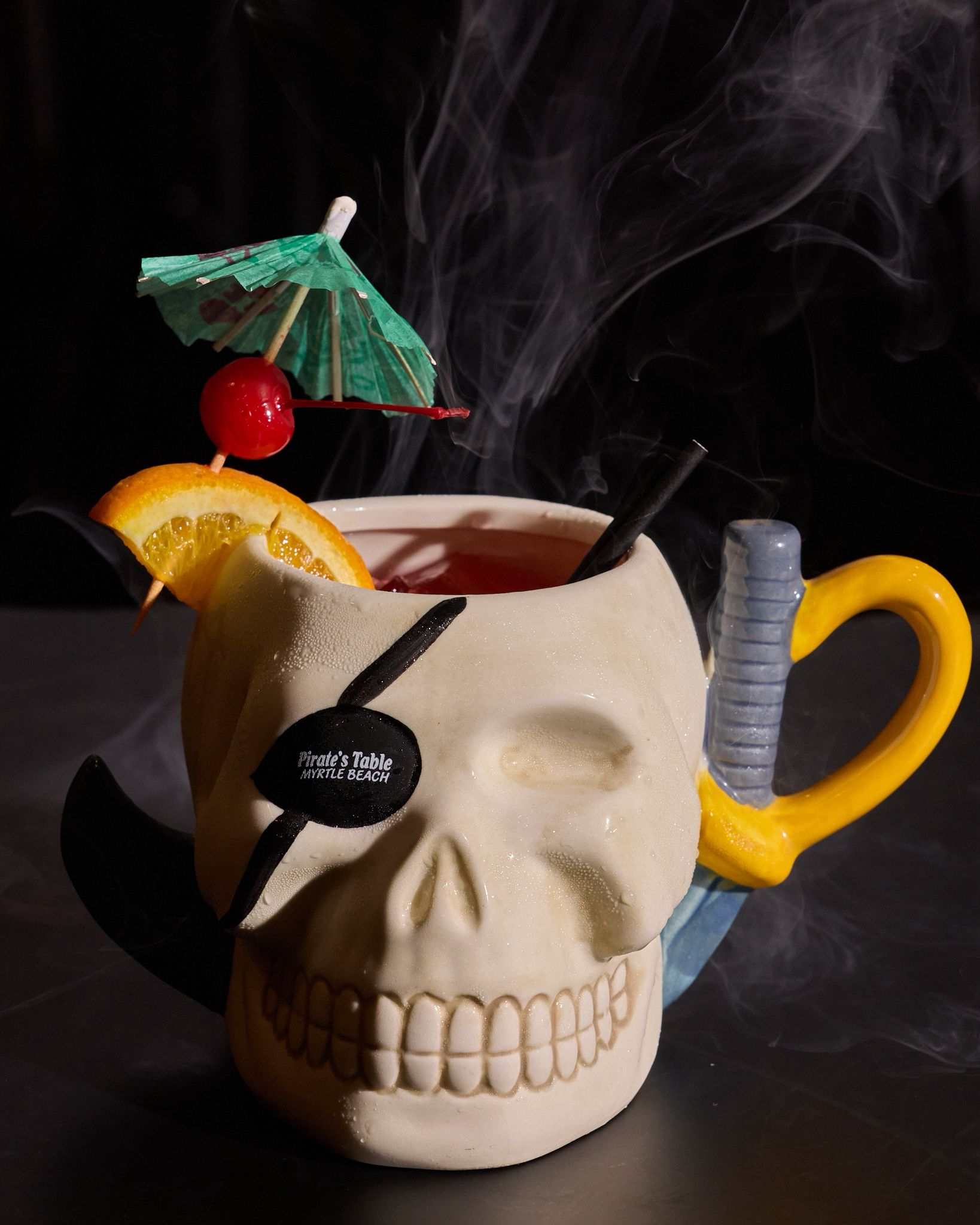 Signature pirate skull mug cocktail with smoke at Pirate's Table Myrtle Beach