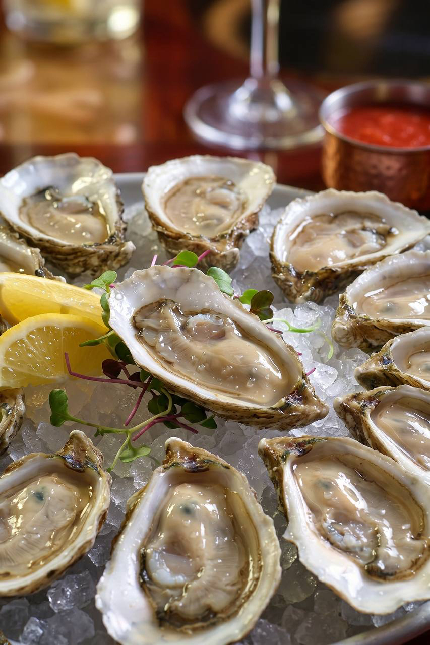 Fresh oysters on the half shell with lemon at Pirate's Table