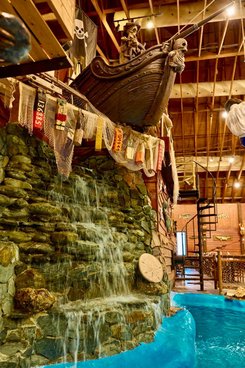 Pirate ship and waterfall inside Pirate's Table restaurant — the mermaid pool